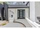 Modern front entrance with black door and sidelights, black house numbers, and decorative planters at 5190 Potters Pike, Indianapolis, IN 46234