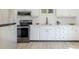 Stylish kitchen features stainless steel appliances, granite countertops, and white cabinets at 5190 Potters Pike, Indianapolis, IN 46234