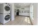 Bright, modern kitchen with white cabinets, stainless steel appliances, and a convenient stacked washer/dryer at 5190 Potters Pike, Indianapolis, IN 46234