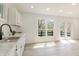 Bright kitchen with white cabinets, stone countertops, and a large window with exterior views at 5190 Potters Pike, Indianapolis, IN 46234