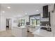 Bright, white kitchen featuring stainless steel appliances, an island, and decorative backsplash at 5190 Potters Pike, Indianapolis, IN 46234