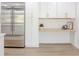 White cabinets and stainless steel fridge alongside a light wood colored desk at 5190 Potters Pike, Indianapolis, IN 46234
