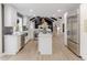 Bright, open kitchen featuring a center island, stainless steel appliances, and hardwood floors at 5190 Potters Pike, Indianapolis, IN 46234