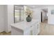 Kitchen island with quartz countertop, stainless steel refrigerator, and decorative flower arrangement at 5190 Potters Pike, Indianapolis, IN 46234