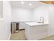 Basement kitchenette includes a wine fridge, white cabinets and modern faucet and sink at 5190 Potters Pike, Indianapolis, IN 46234