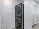 Convenient laundry area with a modern stacked washer and dryer unit in a bright and clean space at 5190 Potters Pike, Indianapolis, IN 46234