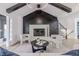 Bright living room featuring a modern fireplace with custom black paneling and black ceiling beams at 5190 Potters Pike, Indianapolis, IN 46234