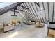 Open-concept living room featuring wood floors, dining area, vaulted ceilings, and neutral furniture at 5190 Potters Pike, Indianapolis, IN 46234