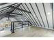 Loft area with black beams, light wood floors, and an open view of the living space below at 5190 Potters Pike, Indianapolis, IN 46234