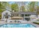 Stunning backyard featuring a pool, patio, and staircase to an upper deck with wood railings at 5190 Potters Pike, Indianapolis, IN 46234