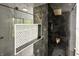 Close up of marble tile shower with modern gold fixtures and built-in tile shelf at 5190 Potters Pike, Indianapolis, IN 46234