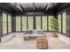 Bright sunroom with large windows, wood-look floors, and a comfortable seating area with a view of the outdoors at 5190 Potters Pike, Indianapolis, IN 46234