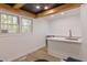 Wet bar with a luxurious marble countertop, stainless steel mini fridge and bright windows at 5190 Potters Pike, Indianapolis, IN 46234