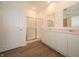 Bright bathroom features a double sink vanity, hard wood floors, and a glass shower at 5204 Cartland Dr, Indianapolis, IN 46239