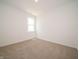 Empty bedroom with a window, plush carpet, and natural light at 5204 Cartland Dr, Indianapolis, IN 46239