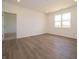 Spacious room with wood floors, a window, and access to adjacent spaces at 5204 Cartland Dr, Indianapolis, IN 46239