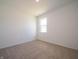 Bright, empty bedroom features neutral carpeting, white walls, white trim and a window at 5204 Cartland Dr, Indianapolis, IN 46239