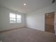 Bedroom with neutral carpet, bright walls, and a large window at 5204 Cartland Dr, Indianapolis, IN 46239