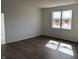 Bedroom featuring a large window providing ample natural light, fresh white paint, and modern wood-look flooring at 5204 Cartland Dr, Indianapolis, IN 46239