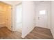 Bright foyer features wood-look flooring, a white front door with glass and access to a bathroom and bedroom at 5204 Cartland Dr, Indianapolis, IN 46239