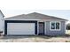 New construction shows a charming single story home with a two-car garage and complementary two-tone paint at 5204 Cartland Dr, Indianapolis, IN 46239
