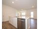 Kitchen island with stainless steel dishwasher and sink overlooking the living area at 5204 Cartland Dr, Indianapolis, IN 46239