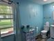 Well-lit bathroom featuring a comfortable toilet and a bright window for natural light at 5282 W Blue Bell Dr, New Palestine, IN 46163