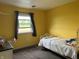 Bright bedroom featuring a window overlooking the outdoors, plus a bed at 5282 W Blue Bell Dr, New Palestine, IN 46163