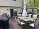 Outdoor deck featuring dining furniture, a grill, and views of the home's exterior and yard at 5282 W Blue Bell Dr, New Palestine, IN 46163