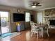 Inviting dining room with a ceiling fan, table with chairs, and access to the outdoor deck at 5282 W Blue Bell Dr, New Palestine, IN 46163