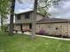 View of the home's exterior showcasing stone accents, landscaping, and a charming front porch at 5282 W Blue Bell Dr, New Palestine, IN 46163