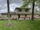 Exterior view of a two-story home with stone features, front porch, and well-kept landscaping at 5282 W Blue Bell Dr, New Palestine, IN 46163