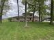 Charming home with stone accents and a well-manicured lawn, surrounded by mature trees at 5282 W Blue Bell Dr, New Palestine, IN 46163