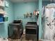 Functional laundry room with modern washer and dryer, plus convenient shelving at 5282 W Blue Bell Dr, New Palestine, IN 46163