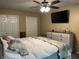 Comfortable main bedroom featuring a ceiling fan, television, and dresser at 5282 W Blue Bell Dr, New Palestine, IN 46163
