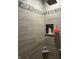 Updated shower stall showcasing decorative tile details and convenient built-in shelving at 5282 W Blue Bell Dr, New Palestine, IN 46163