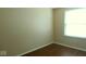 Empty bedroom features wood flooring and window with bright, natural light at 5415 Wagon Wheel Trl, Indianapolis, IN 46237