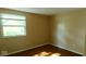 Empty bedroom features wood flooring and large window with natural light at 5415 Wagon Wheel Trl, Indianapolis, IN 46237