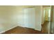 Bedroom with standard closet features wood flooring and view to hallway at 5415 Wagon Wheel Trl, Indianapolis, IN 46237