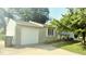 Charming home featuring an attached garage, well-manicured lawn, and inviting front porch at 5415 Wagon Wheel Trl, Indianapolis, IN 46237