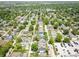 An aerial view showcases a vibrant neighborhood with tree-lined streets and well-maintained homes at 544 N Beville Ave, Indianapolis, IN 46201