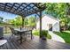 Inviting backyard deck with a pergola, outdoor dining set, and lush landscaping at 544 N Beville Ave, Indianapolis, IN 46201