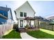 Backyard featuring a wooden deck with a pergola, outdoor seating, grill, lush lawn, and modern white siding at 544 N Beville Ave, Indianapolis, IN 46201