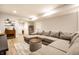 Comfortable basement area featuring a large sectional sofa, a small bar, and light wood floors at 544 N Beville Ave, Indianapolis, IN 46201