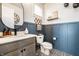 Stylish powder room with a gray vanity, modern fixtures, decorative mirror, and patterned tile flooring at 544 N Beville Ave, Indianapolis, IN 46201