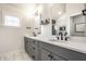 Bright bathroom featuring double vanity with gray cabinets, modern fixtures, and a glass-enclosed shower with tile at 544 N Beville Ave, Indianapolis, IN 46201
