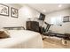 Bedroom with a bed, treadmill, bench, dresser, and tv for a dedicated exercise and living space at 544 N Beville Ave, Indianapolis, IN 46201