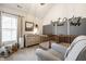Bedroom with crib, dresser, and gray accent wall featuring personalized name decor and a comfortable armchair at 544 N Beville Ave, Indianapolis, IN 46201