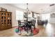 Open-concept dining area with modern chandelier and seamless flow into the kitchen at 544 N Beville Ave, Indianapolis, IN 46201