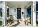 Inviting front porch with rocking chair, potted plants, and stylish front door with wreath at 544 N Beville Ave, Indianapolis, IN 46201